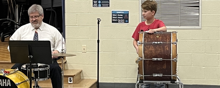 Member of Music in Our Schools playing a song during the assembly